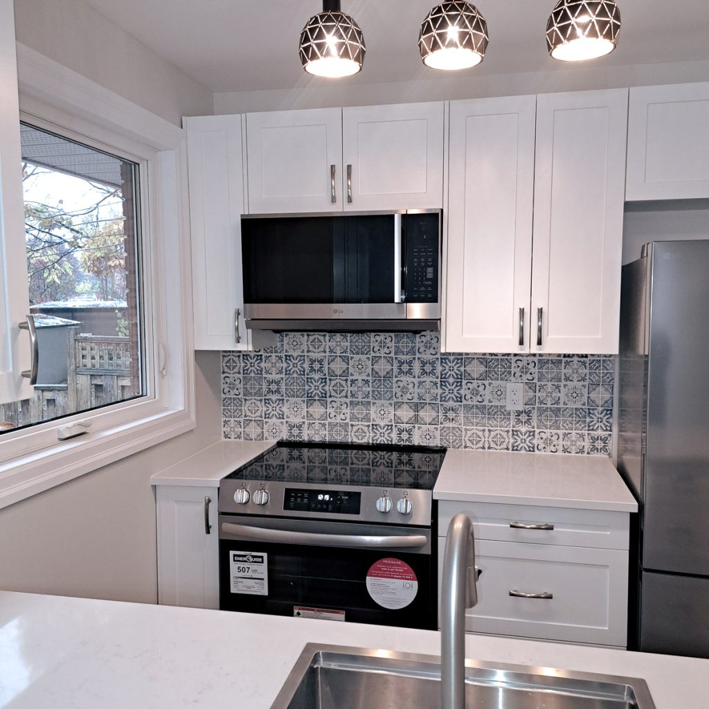 photo of new cabinet faces appliances and lighting coordinated and installed by Keith Gagnier Property Owner Services